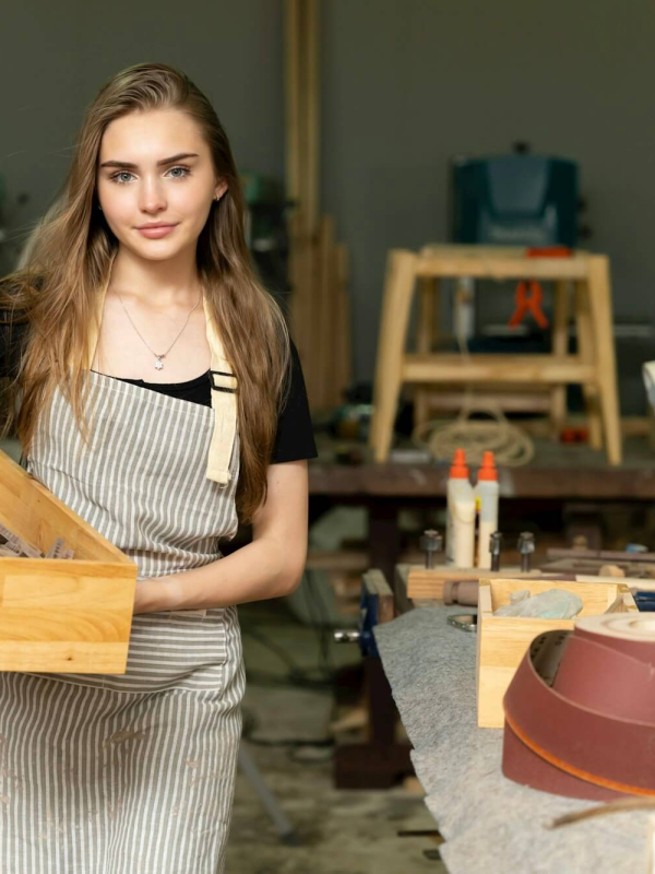 a-female-carpenter-is-working-at-a-furniture-factory.jpg